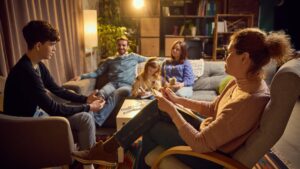 Therapist leading family counseling session with parents and teenage child family therapy in teen addiction recovery